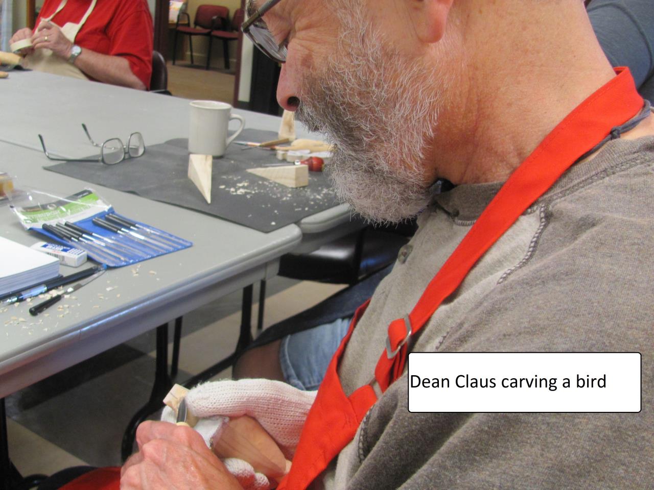 Dean Claus carving a bird block