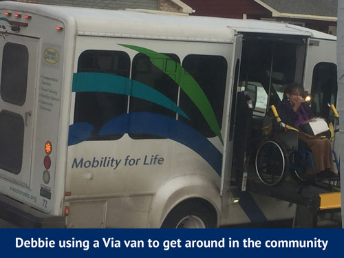 Debbie riding the Via van