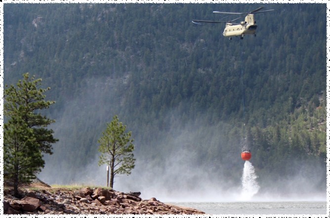 helicopter carrying water at Button Rock Preserve