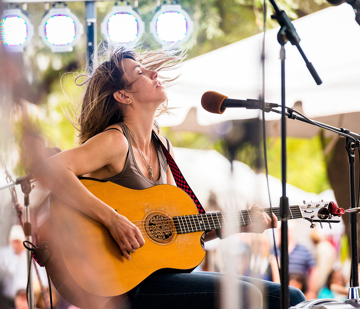 Tiffany Christopher playing guitar at a folk fest