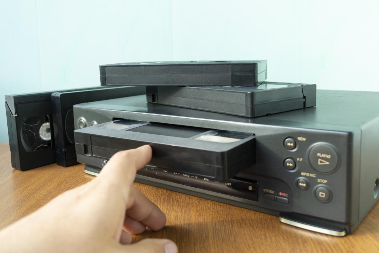 Hand loading VCR with videotape