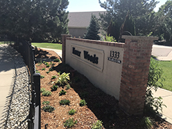 Water wise garden plants are newly planted in front of the Hover Woods neighborhood entry sign