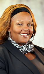 Shiquita Yarbrough, a 50-year-old black woman wearing a teal blouse, sits for a portrait for City Council