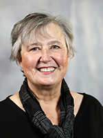 Marcia Martin, an older white woman wearing a black blouse and shirt, sits for a portrait for City Council