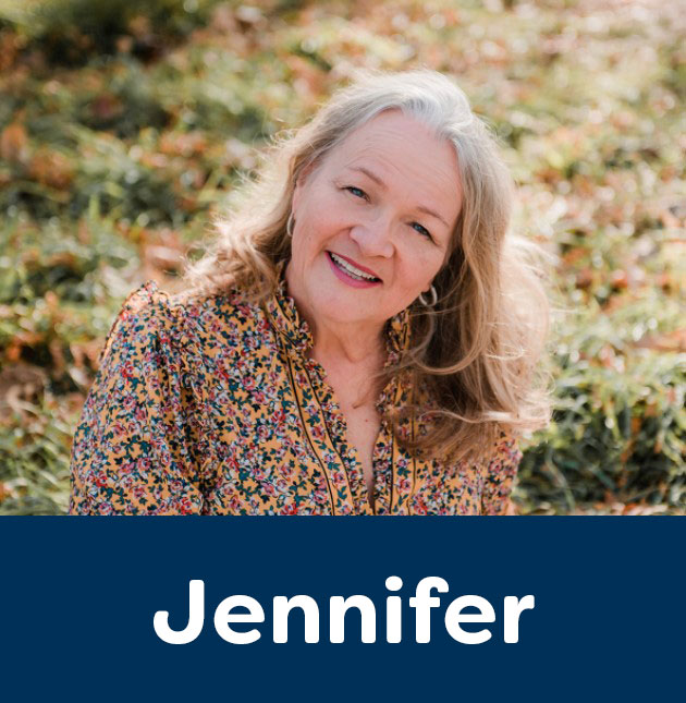 Jennifer smiling in a field of flowers