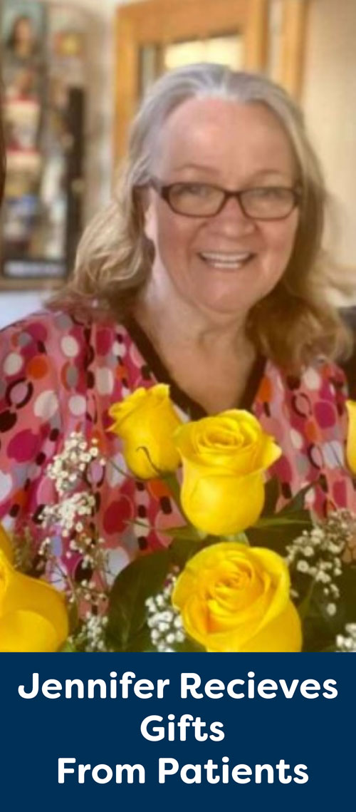 Jennifer with yellow roses and gifts from clients