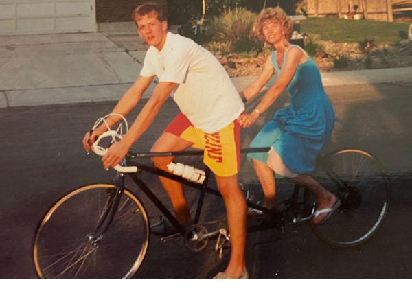 Chris riding tandem with his mom high school years a