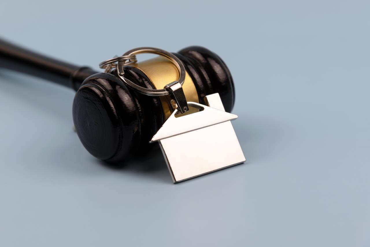 A gavel appears with a house-shaped keychain