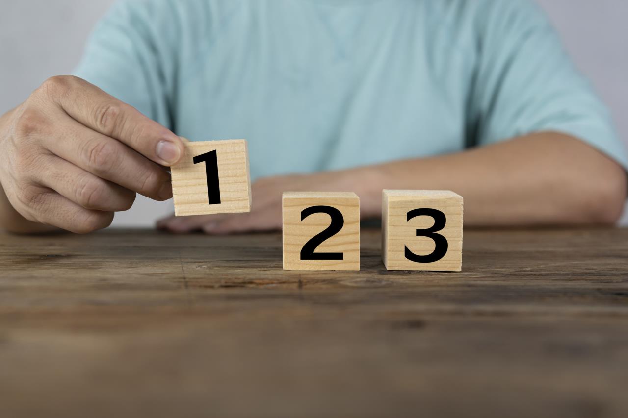Man setting up blocks that count 1 2 3