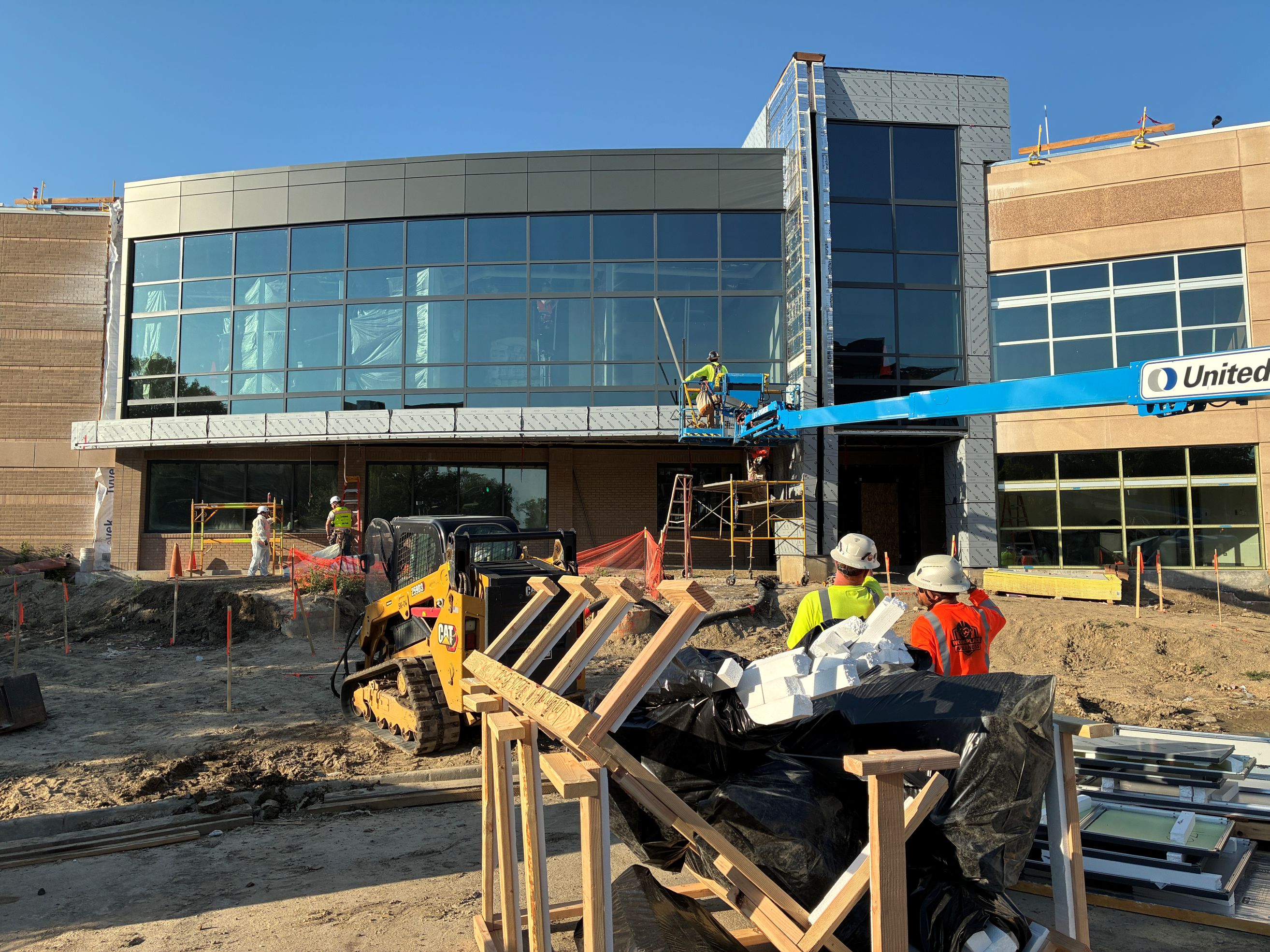 photo of the front of the Safety and Justice Center under construction with trucks and workers in the foreground.