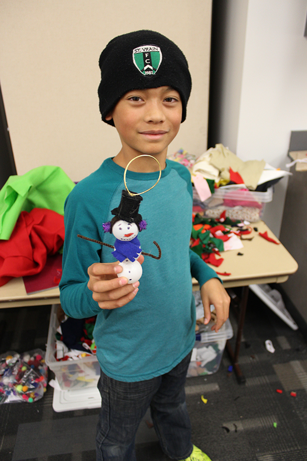 A child holding a snowman ornament