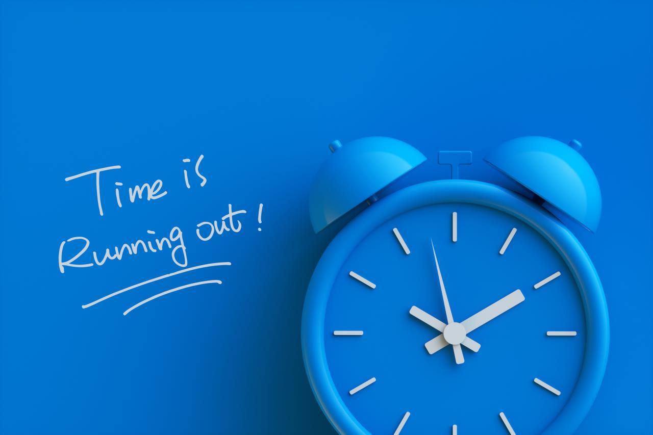 Blue clock with Time Is Running Out nearby