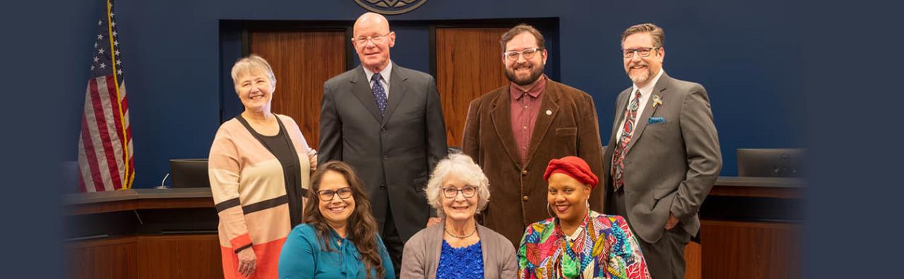 Members of the Longmont City Council pose for a picture in the City Council Chambers. Top from left to right: Martin Martin, Tim Waters, Aren Rodriguez, and Sean McCoy; Bottom from left to right: Susie Hidalgo-Fahring, Mayor Joan Peck and Shiquita Yarbrough