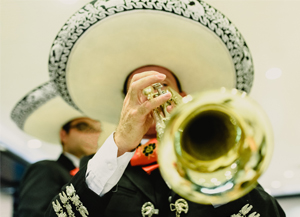 Mariachi band member playing a trumpet