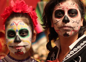 Couple dressed and make up done to represent sugar skulls for Day of the Dead