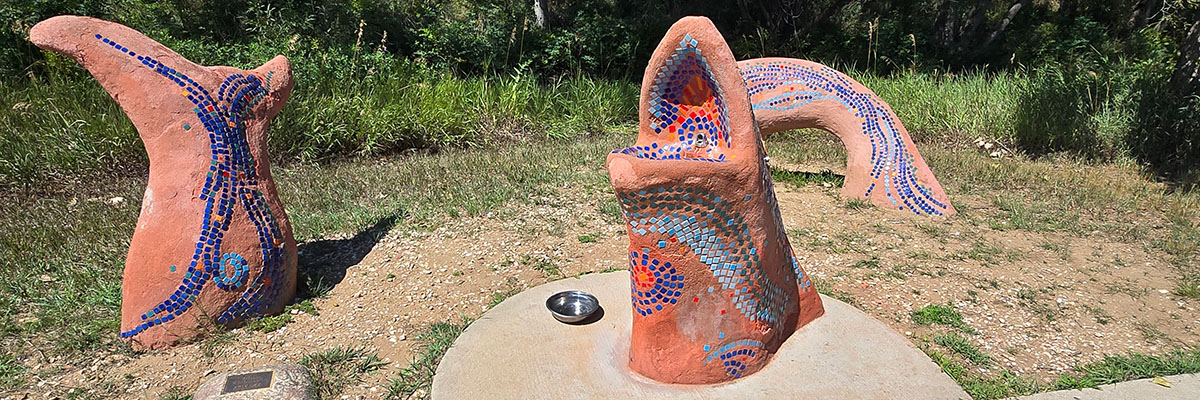 NATURE’S WAY by Tim Watkins (2000) is an Art in Public Places piece adjacent to the Southmoor Park Greenway (part of Longmont’s Lefthand Greenway) near Missouri Avenue. Watkins’ colorful and whimsical pieces include this fish drinking fountain, a “bat bench,” chairs encompassed by an aroma garden, an “eye spy” and a kinetic archway.