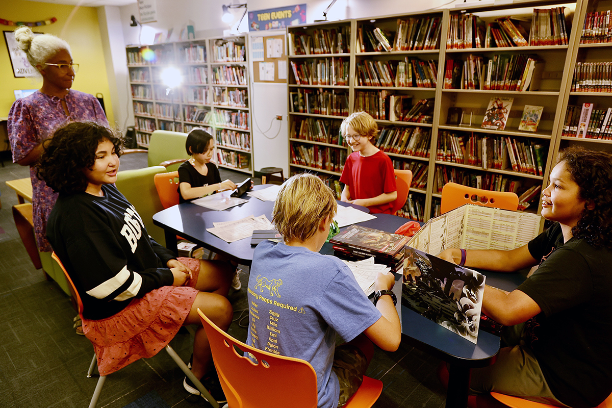 A group of middle schoolers play Dungeons and Dragons in the Teen Room of the Library