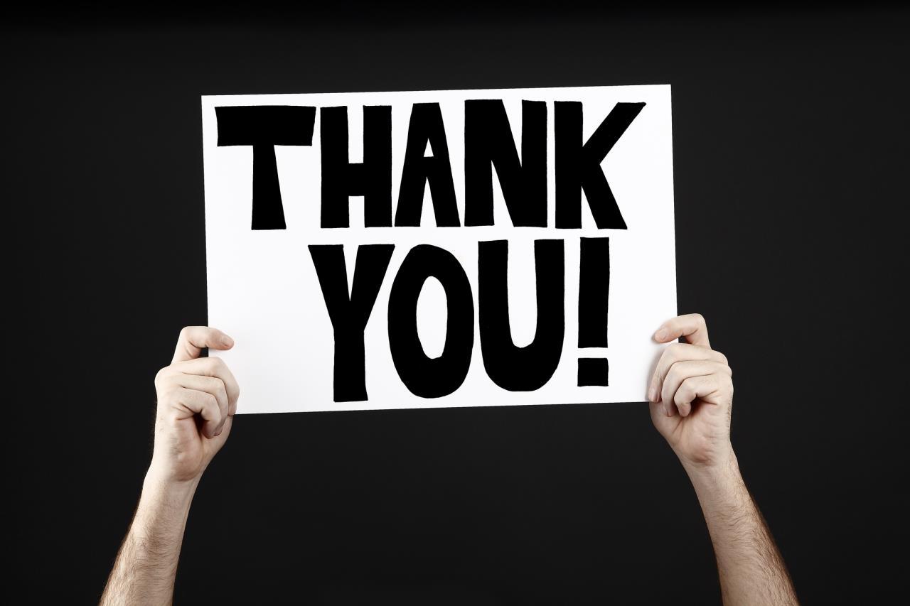 Hands holding up a Thank You sign