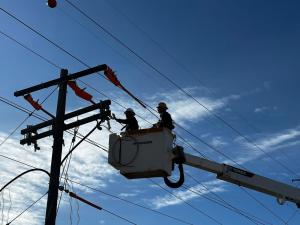 Line crew in bucket truck working on overhead line