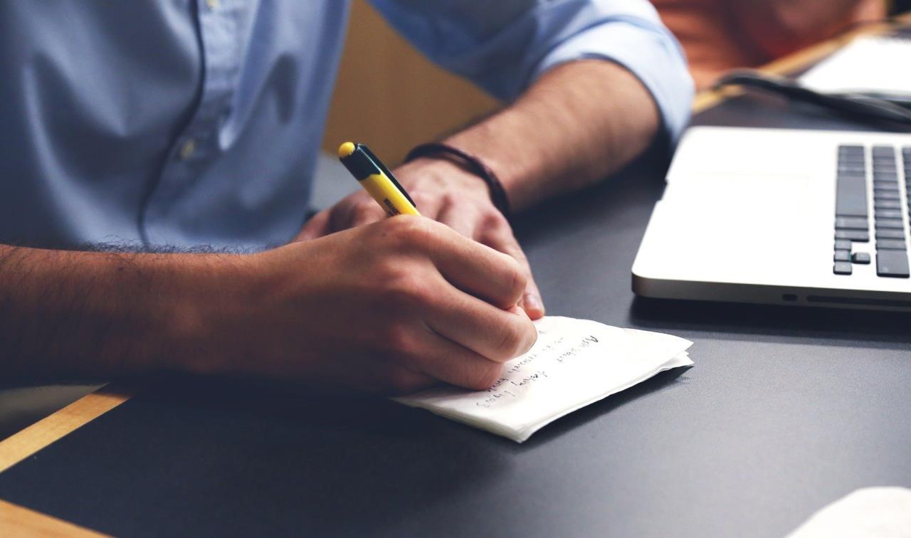 Man Writing Notes or List