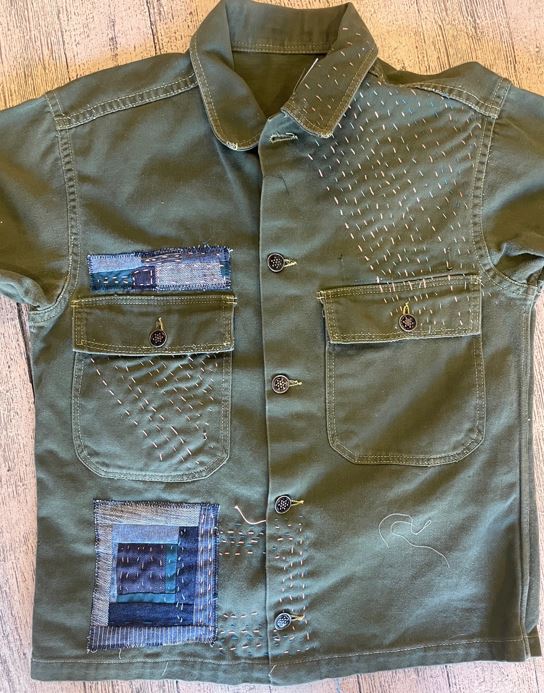 A shirt that has been mended with artistic sewing