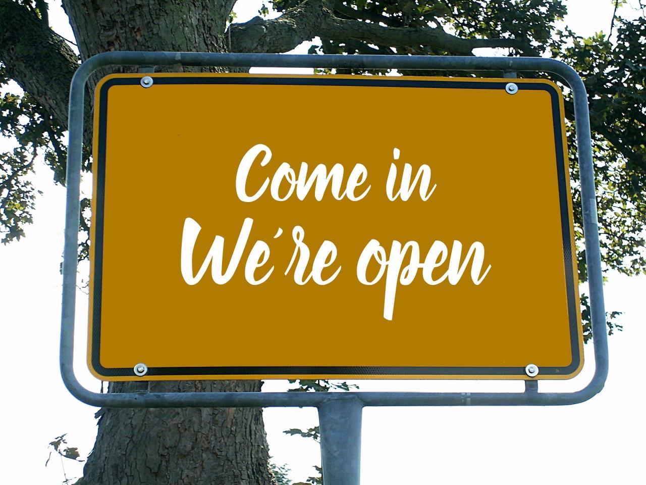 Come In We're Open Sign In Front of Tree