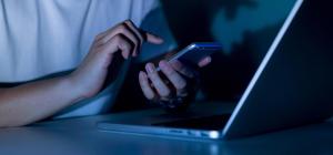 Telephoning At Night In Front of Laptop