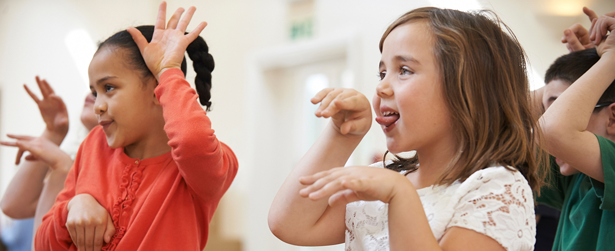 Group Of Children Enjoying Drama Class Together