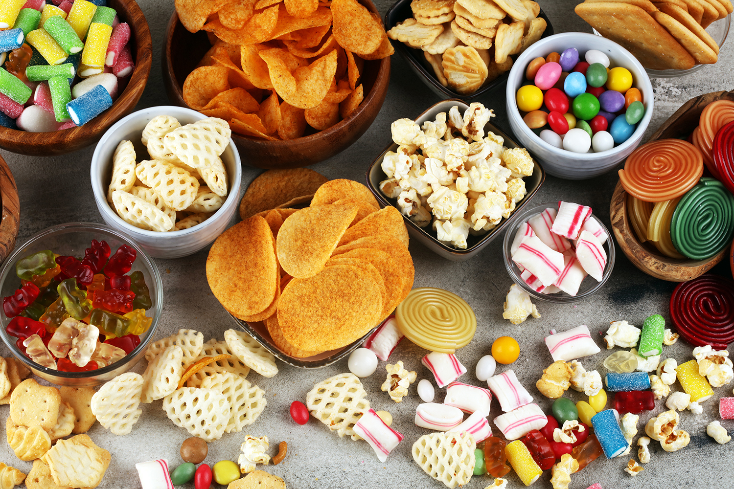 Salty snacks. Pretzels, chips, crackers and candy sweets. Unhealthy products. food bad for figure, skin, heart and teeth. Assortment of fast carbohydrates food.