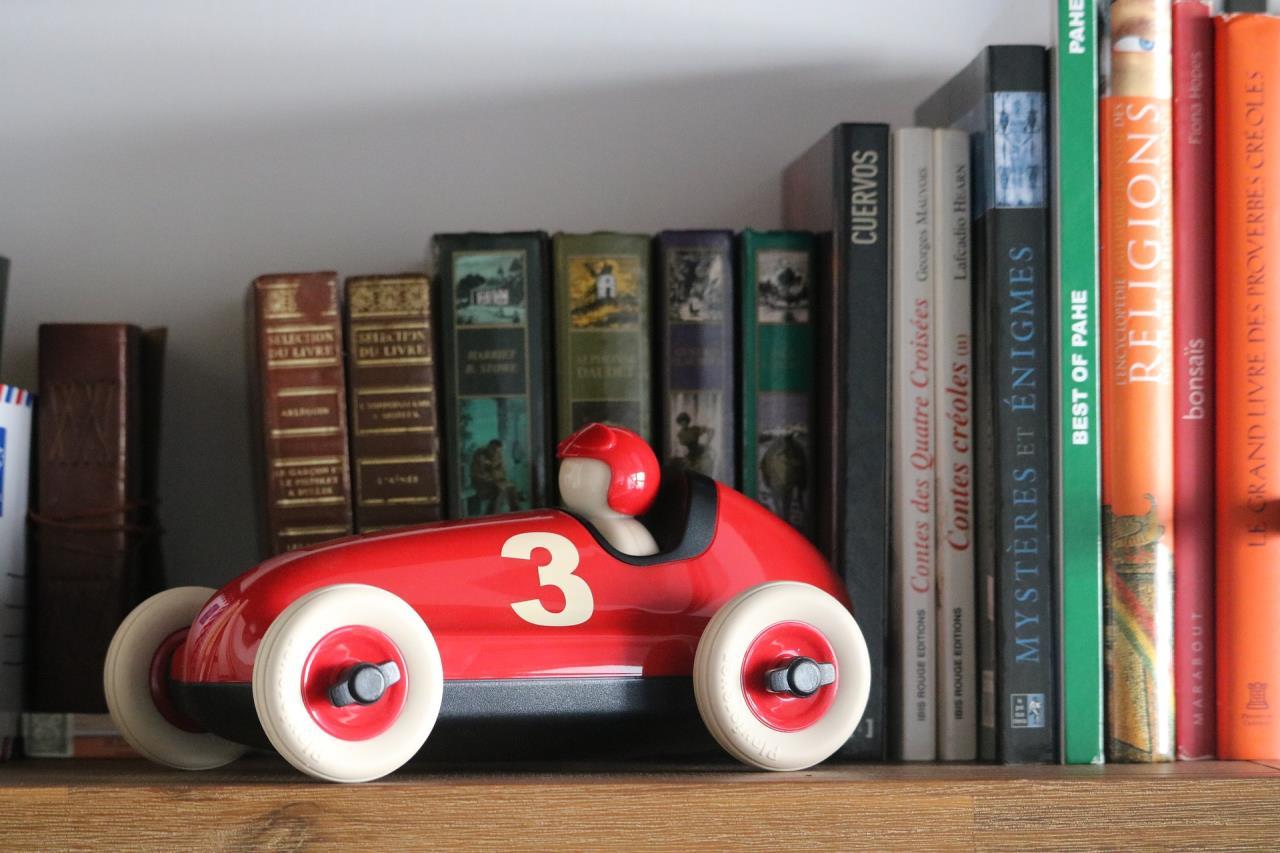 Toy car on library bookshelf