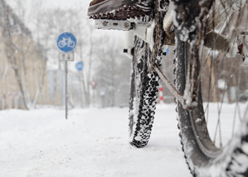 A person is riding a bicycle on snow