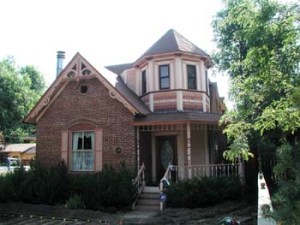 The Webb House, at 536 Collyer Street, is pictured. It is a Queen Anne style house with a turret.