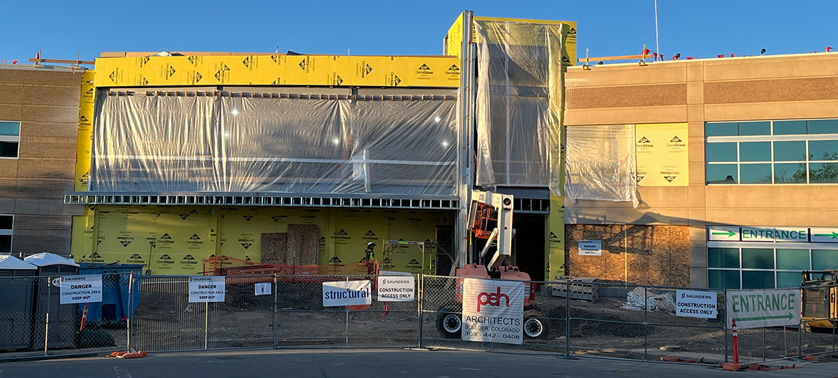 The Longmont Safety $ Justice Center is seen in construction in April 2026. Plastic sheeting covers large areas that will soon contain glass.