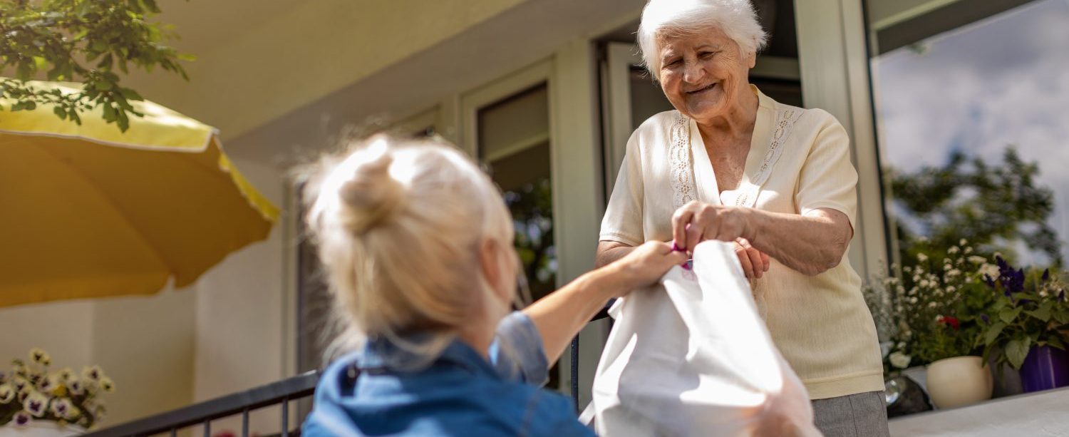 A volunteer delivers materials to a homebound library patron