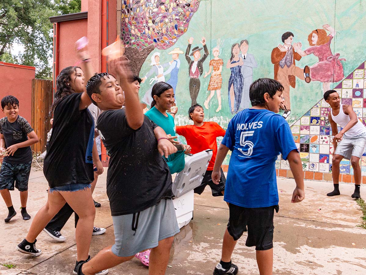 Youth play with water balloons outside of the Longmont Youth Center.