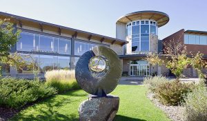 Museum exterior featuring glass windows and a sculpture