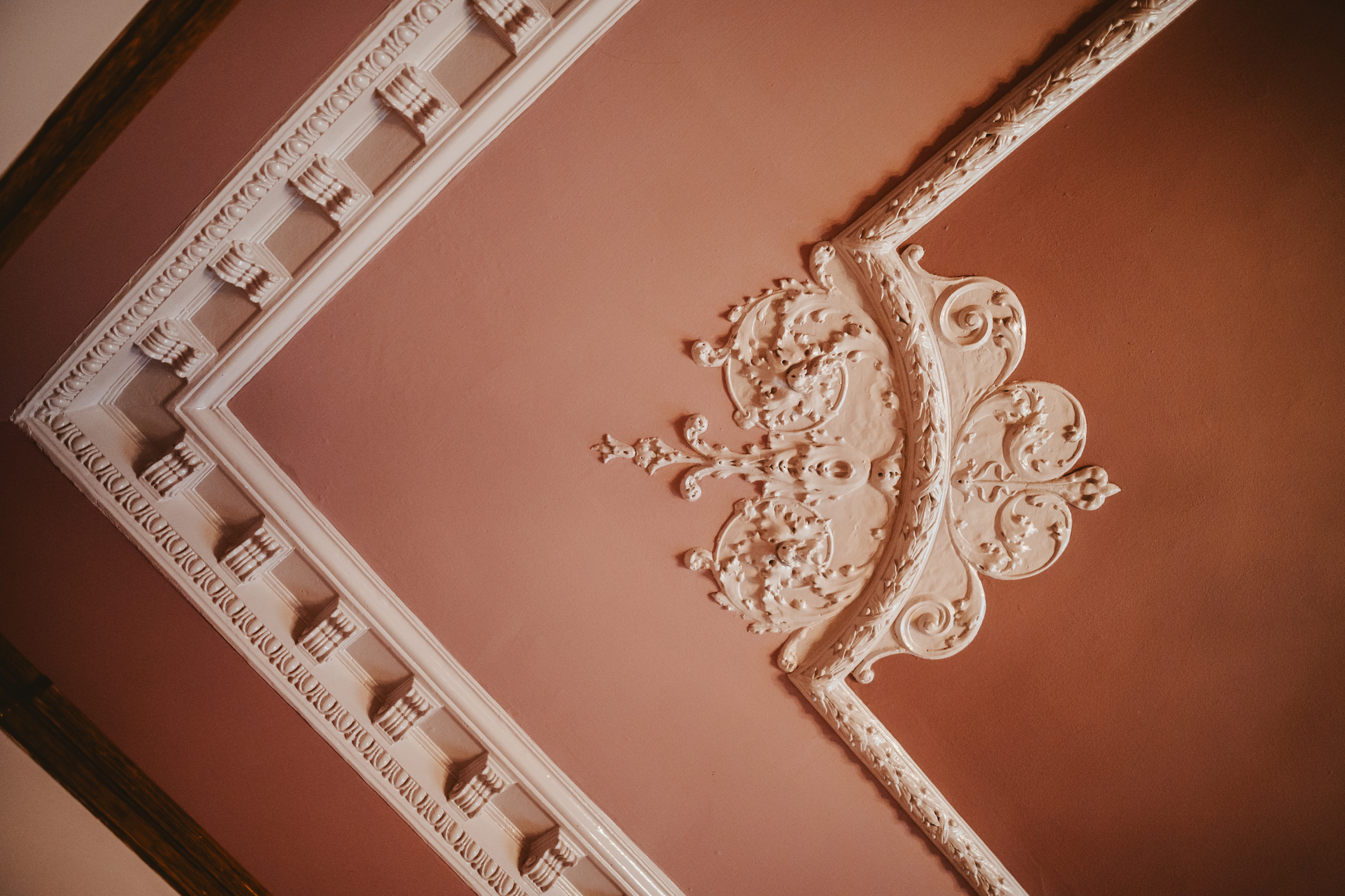 Intricate pink and white crown molding