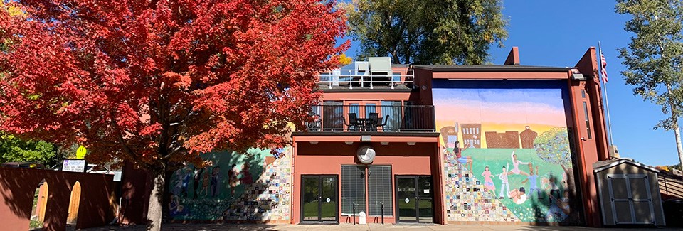 The Longmont Youth Center building is surrounded by colorful trees each autumn.