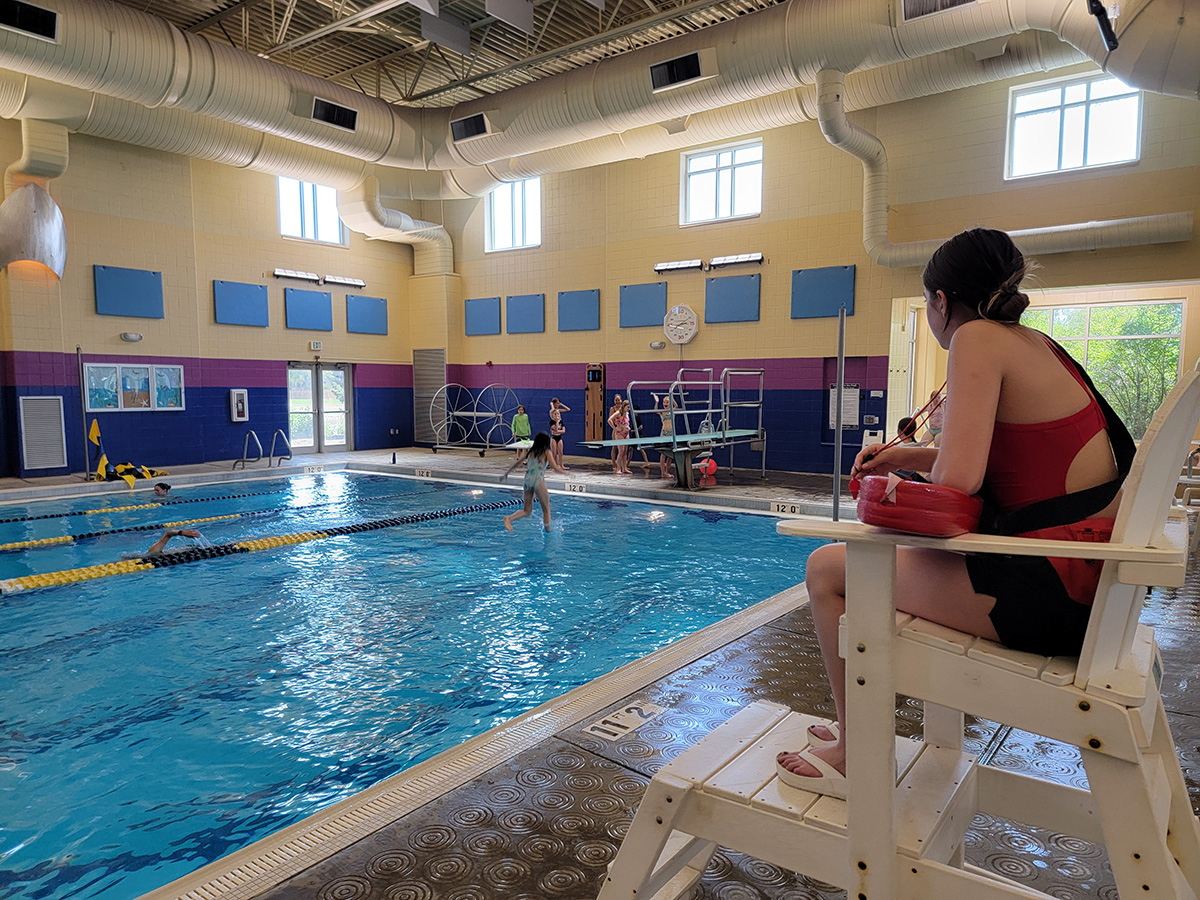 Lap pool at Longmont Recreation Center during lap swim with a lifeguard in the foreground.