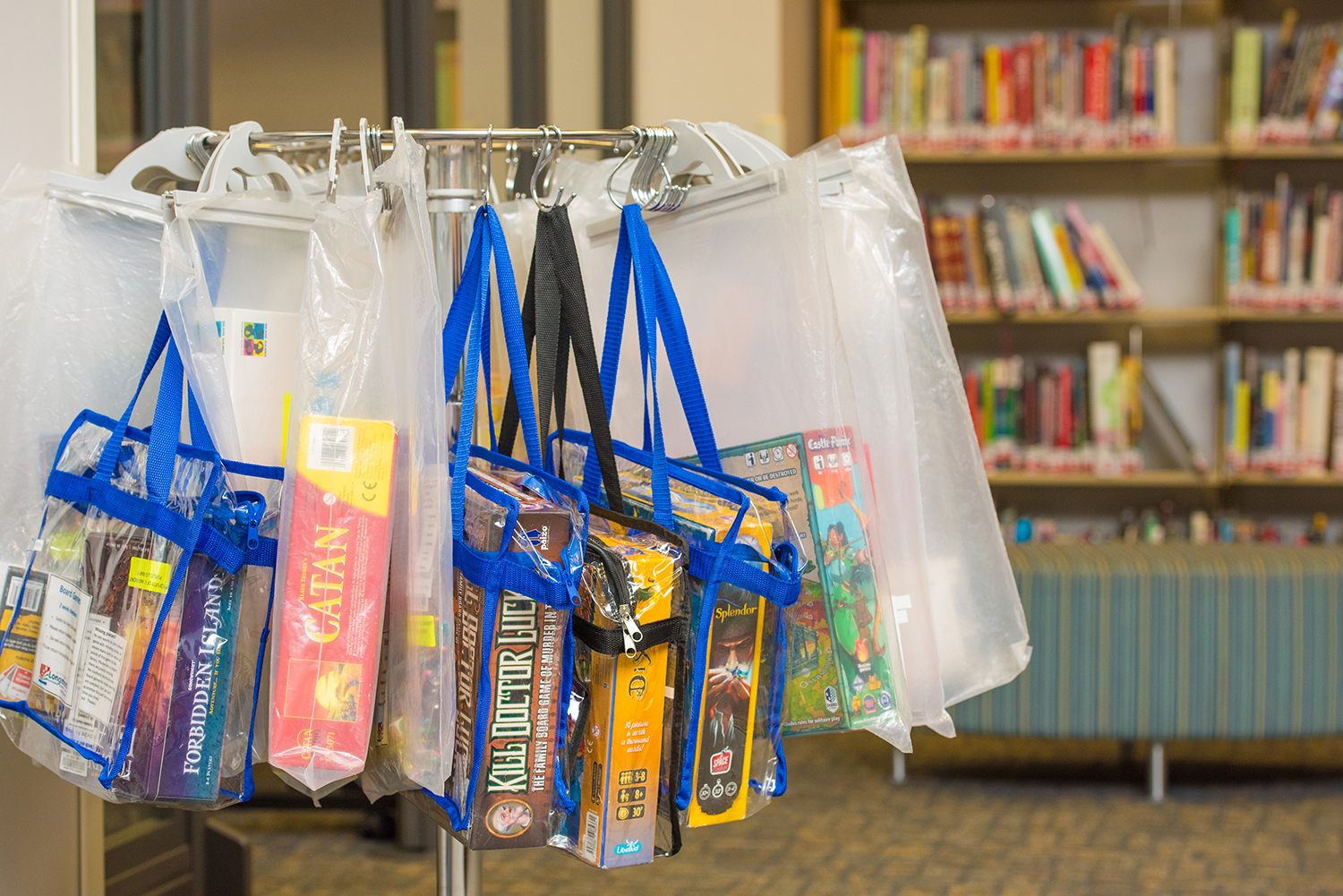 A rack displays a variety of board games at the Library