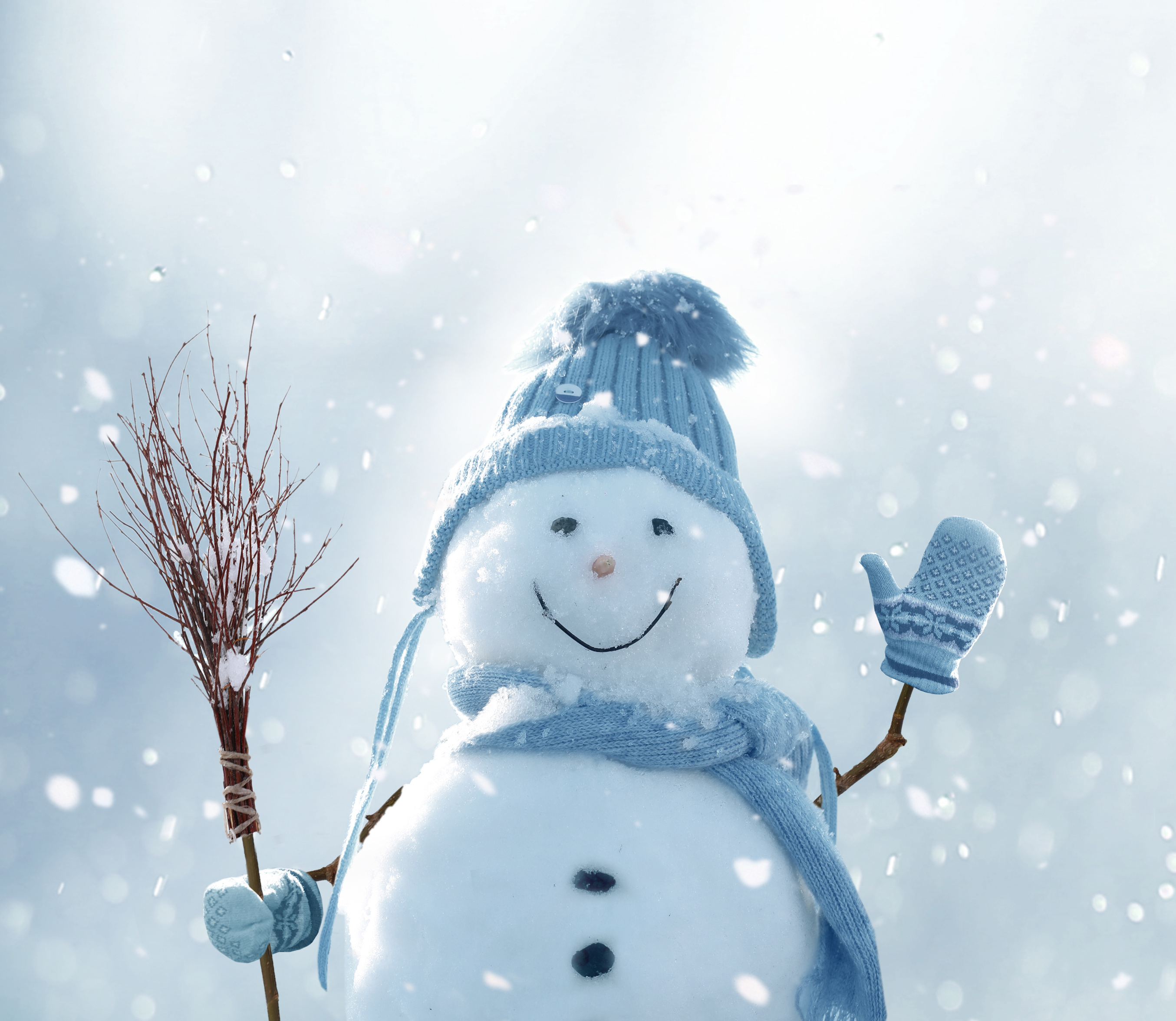 Cute smiling snowman with blue scarf and hat with a broom in his