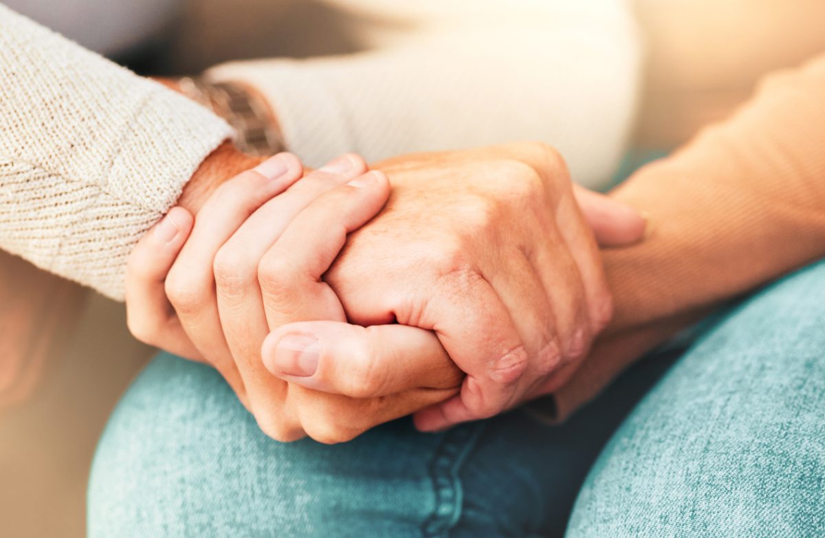 A pair of hands clasping each other.