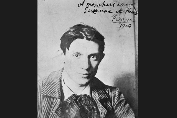 Black and white image of young Picasso with writing in top right corner