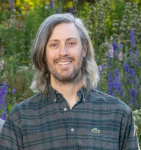 Kevin Philip Williams Headshot against botanical background 