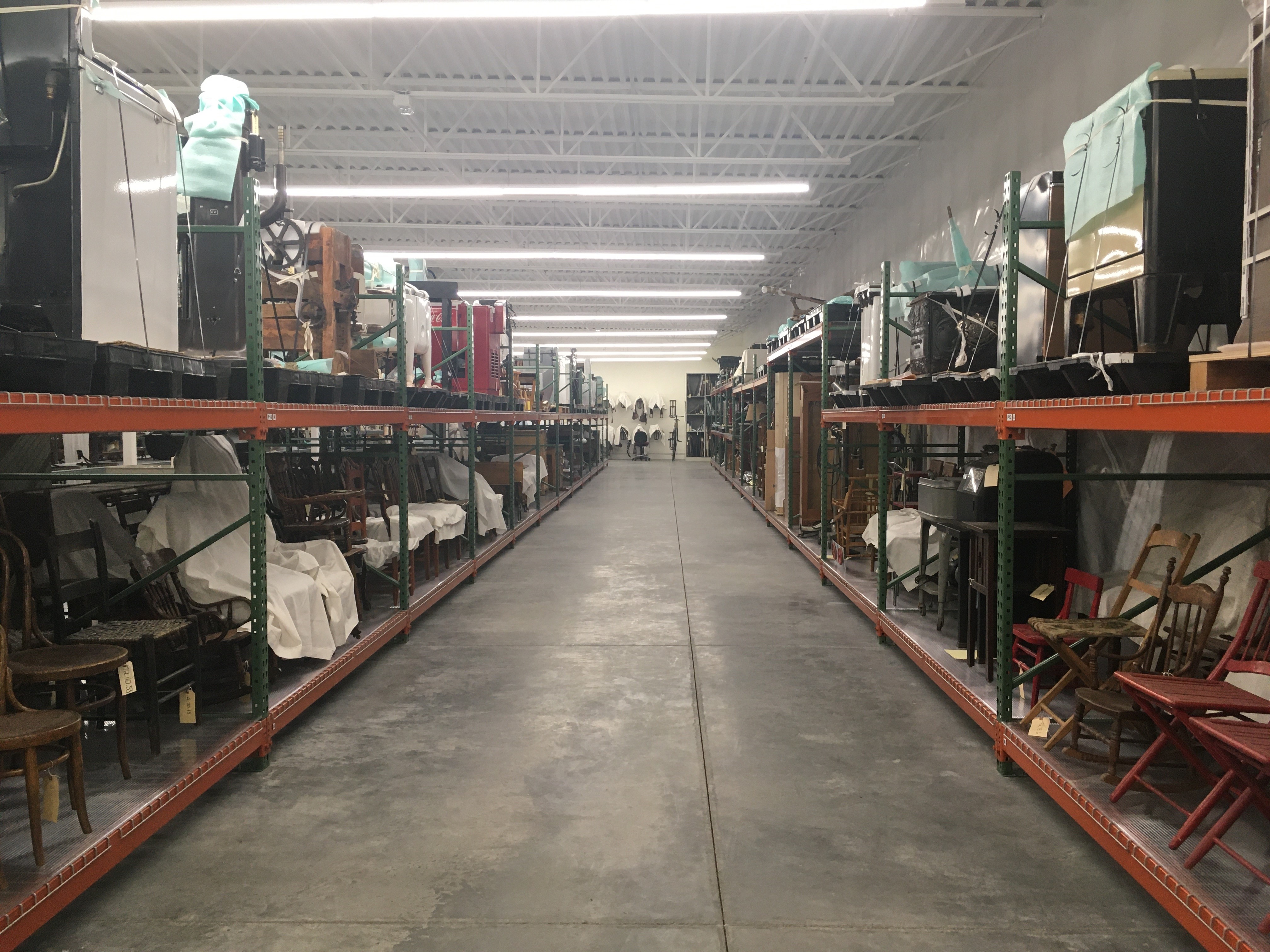 Museum collection center shelving with antique furniture