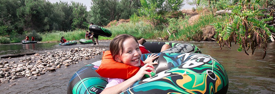 Kids are riding inner tubes down the St. Crain Creek.