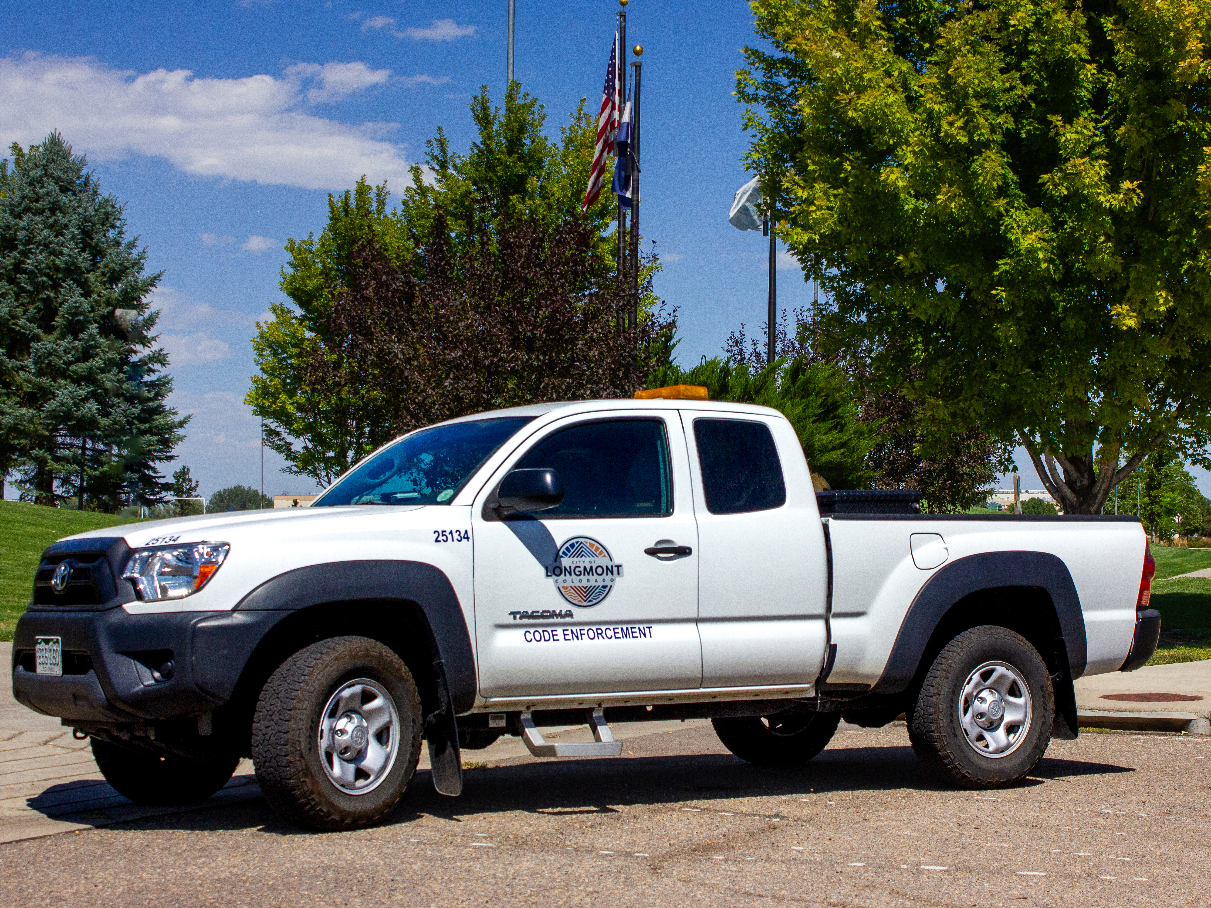 White Pickup Truck with City of Longmont Logo and Code Enforcement Label on the Side