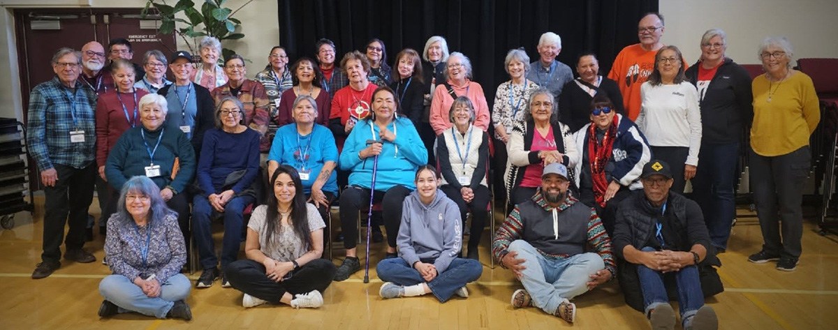 Dozens of participants, of the March 2025 Elder Exchange between the Northern Arapaho and the City of Longmont, pose for a photo in the Longmont Senior Center.