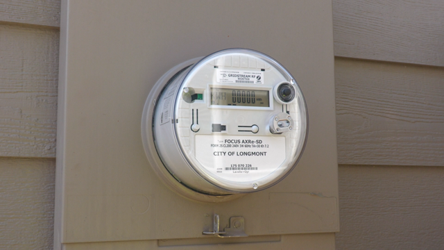 Advanced electric meter on the outside wall of a building, with a digital reading of 00000.