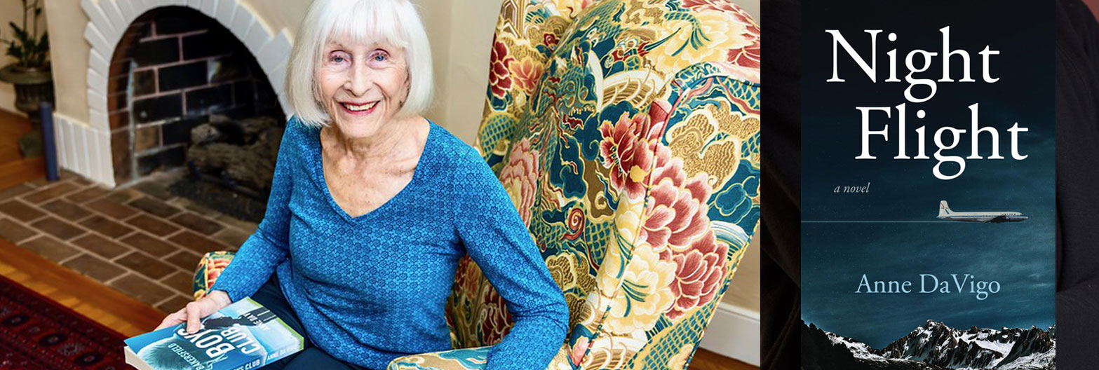 Author of Night Flight Anne da Vigo Author in a chair holding a book